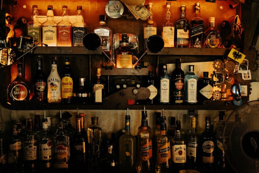 a bar with many bottles of alcohol on the shelves